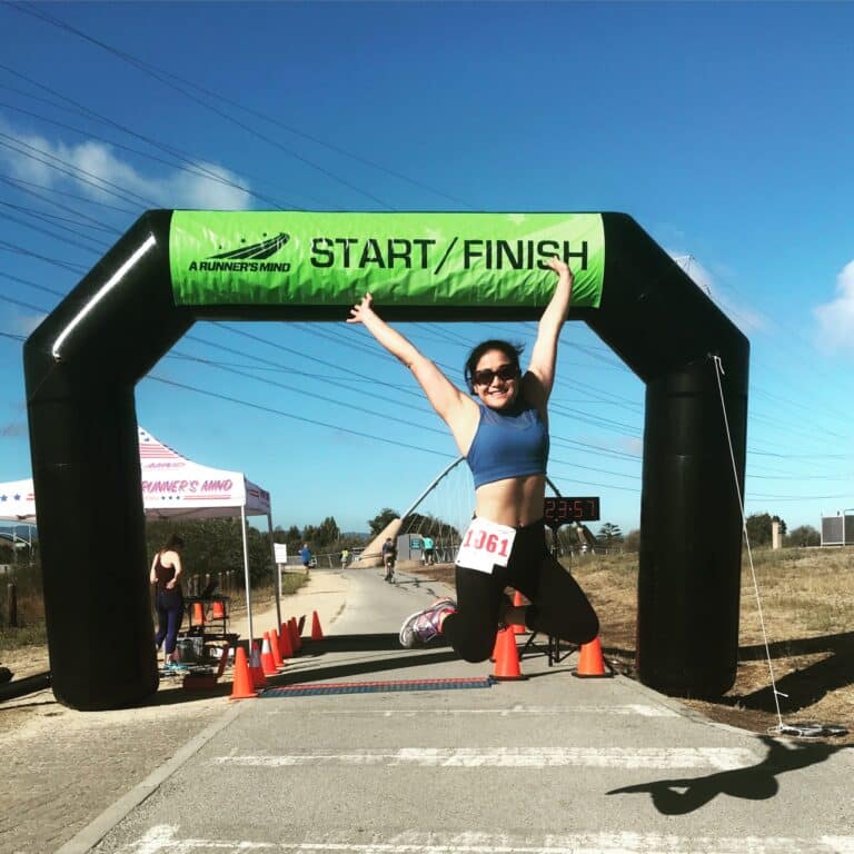 Angel Riley jumping up at the finish line