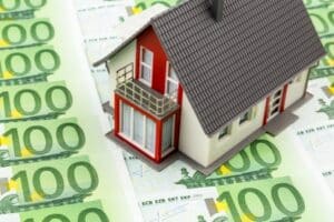 house on bills, symbolic photo for home purchase