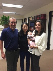 Chauvel and Glatt attorneys holding a baby
