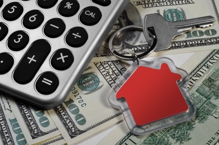 calculator, money and house key