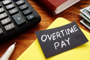Text sign showing hand written words Overtime pay