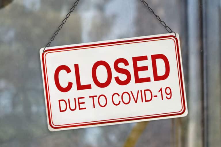 Closed sign due to Covid-19, Coronavirus outbreak lockdown, on the window of a shop. Economic crisis concept
