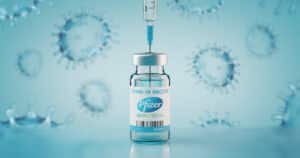 Pfizer Biontech Covid-19 Vaccine and injection syringe.